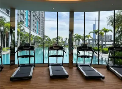 a gym with a swimming pool in a building at Trion KL Premium Suite in Kuala Lumpur