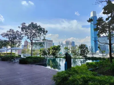a park with a water fountain and a city at Charming Haven in Kuala Lumpur 100Mb TRX Mall in Kuala Lumpur