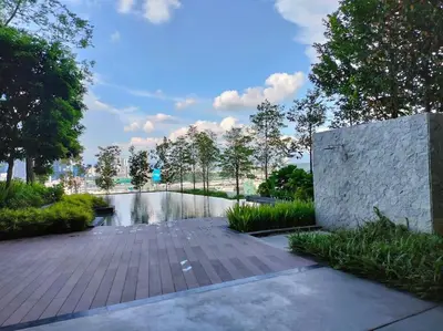 a walkway with a pond in a park at Charming Haven in Kuala Lumpur 100Mb TRX Mall in Kuala Lumpur