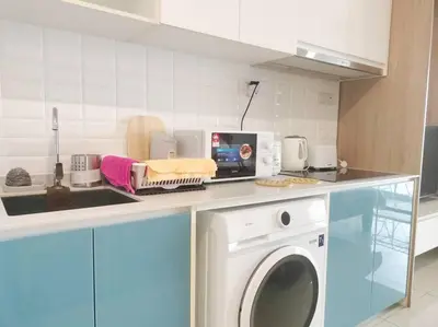 a kitchen with a washing machine on a counter at Charming Stay in the Heart of Kuala Lumpur 100Mb in Kuala Lumpur
