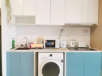 a kitchen with a washing machine on a counter at Charming Stay in the Heart of Kuala Lumpur 100Mb in Kuala Lumpur