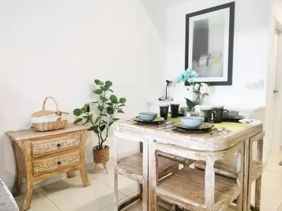 a table with plates and bowls on it in a room at Charming Stay in the Heart of Kuala Lumpur 100Mb in Kuala Lumpur