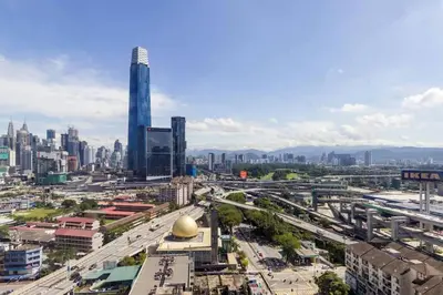 a city with tall buildings and a street with cars at 2Bedroom near TRX By RumaBnb in Kuala Lumpur