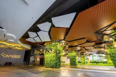 a building with plants and lights on the ceiling at 2Bedroom near TRX By RumaBnb in Kuala Lumpur