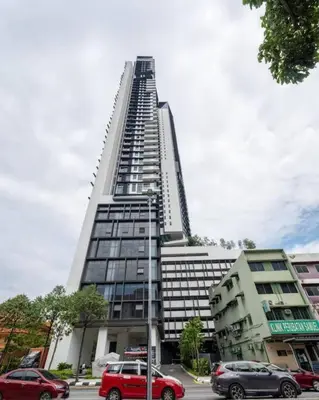 a tall building with cars parked in front of it at 2Bedroom near TRX By RumaBnb in Kuala Lumpur