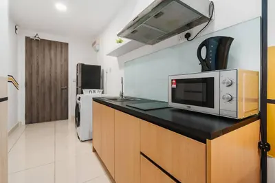 a kitchen with a microwave on top of a counter at 2Bedroom near TRX By RumaBnb in Kuala Lumpur