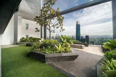 a garden on a building with a view of the city at 2Bedroom near TRX By RumaBnb in Kuala Lumpur