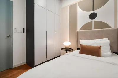 a bedroom with a white bed with a brown pillow at M Vertica Cheras by Xuites - 7 pax - Free Netflix - MRT at 500m - 15 mins to KLCC & TRX in Kuala Lumpur