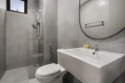 a bathroom with a sink and a toilet and a mirror at M Vertica Cheras by Xuites - 7 pax - Free Netflix - MRT at 500m - 15 mins to KLCC & TRX in Kuala Lumpur