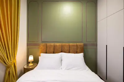 a bedroom with a bed with white pillows at M Vertica Cheras by Xuites - 7 pax - Free Netflix - MRT at 500m - 15 mins to KLCC & TRX in Kuala Lumpur