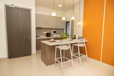 a kitchen with a island with bar stools in it at M Vertica Cheras by Xuites - 7 pax - Free Netflix - MRT at 500m - 15 mins to KLCC & TRX in Kuala Lumpur