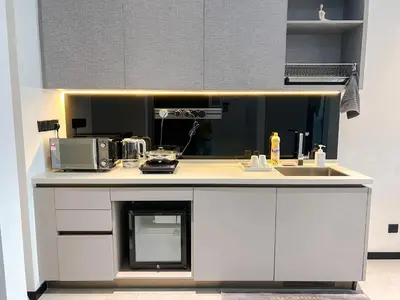 a white kitchen with a sink and a microwave at OPUS Kuala Lumpur by Scape Stay in Kuala Lumpur