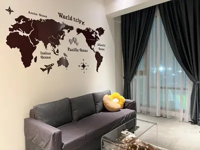 a living room with a couch and a world map on the wall at OPUS Kuala Lumpur by Scape Stay in Kuala Lumpur