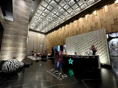 a lobby with a large screen in the middle at Star Residence KLCC By M&T in Kuala Lumpur