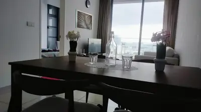 a dining room table with flowers and glasses on it at Pool Haven Reservations in Kuala Lumpur