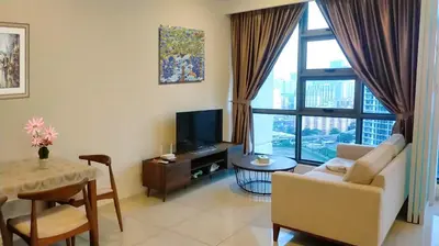 a living room with a couch and a tv and a table at Pool Haven Reservations in Kuala Lumpur