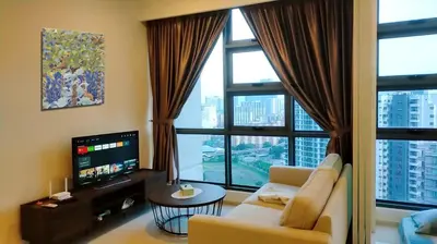 a living room with a couch and a large window at Pool Haven Reservations in Kuala Lumpur