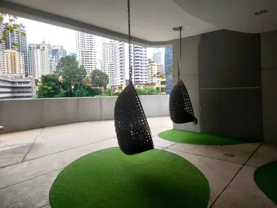 a room with a green rug and two chairs at Pool Haven Reservations in Kuala Lumpur