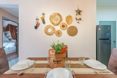 a dining room table with plates and utensils at MVB36#Bali Style 3 Rooms Family Suite M Vertica Velocity Mall Cheras in Kuala Lumpur