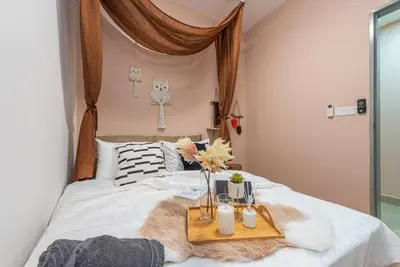a bed with a tray with flowers and candles on it at MVB36#Bali Style 3 Rooms Family Suite M Vertica Velocity Mall Cheras in Kuala Lumpur