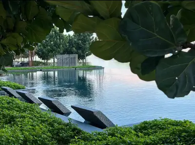 a pool of water with a row of benches at MVB36#Bali Style 3 Rooms Family Suite M Vertica Velocity Mall Cheras in Kuala Lumpur