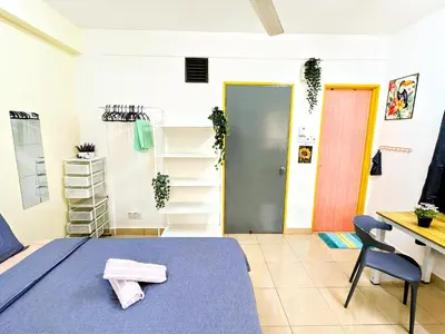 a room with a bed and a desk and a table at Private Room with Bathroom in Kuala Lumpur