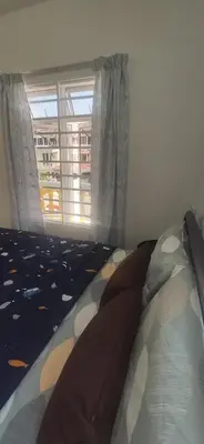 a bedroom with a bed and a window at Hostel Room with Private Bathroom in Kuala Lumpur