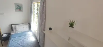 a bedroom with a bed and a window at Hostel Room with Private Bathroom in Kuala Lumpur