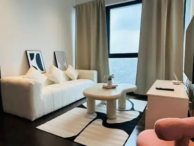 a living room with a white couch and a table at V Residence Suites-27 in Kuala Lumpur