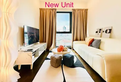 a living room with a white couch and a new unit at V Residence Suites-27 in Kuala Lumpur