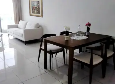 a living room with a table and chairs and a couch at 2-Bed Luxury Resort Robertson in Kuala Lumpur