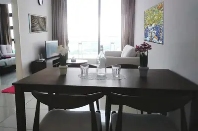 a dining room table with chairs and a bottle and glasses at 2-Bed Luxury Resort Robertson in Kuala Lumpur