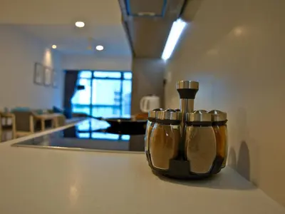 a kitchen counter with three spice bottles on it at Eaton Residence Yemala in Kuala Lumpur