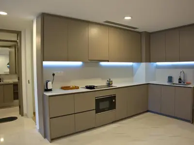 a kitchen with brown and white cabinets and appliances at Eaton Residence Yemala in Kuala Lumpur