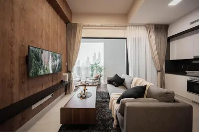 a living room with a couch and a tv at NaiBnB in The Colony by Infinitum in Kuala Lumpur