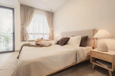 a large bed in a bedroom with a window at NaiBnB in The Colony by Infinitum in Kuala Lumpur