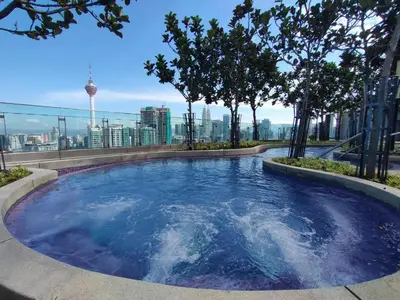 a lap pool on the roof of a building with trees at The Robertson-Bukit Bintang by PILLOWTALKS in Kuala Lumpur