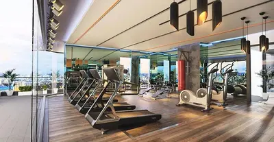 a gym with several tread machines in a room at The Robertson-Bukit Bintang by PILLOWTALKS in Kuala Lumpur