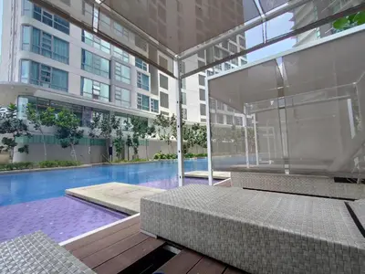 a large building with a swimming pool in front of a building at The Robertson-Bukit Bintang by PILLOWTALKS in Kuala Lumpur