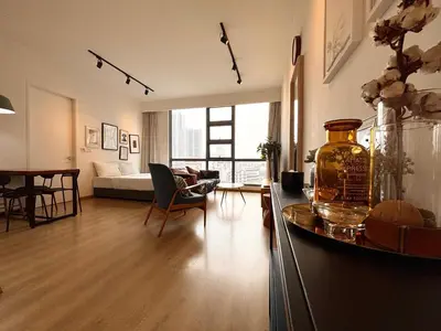 a large living room with a couch and a table at The Robertson-Bukit Bintang by PILLOWTALKS in Kuala Lumpur