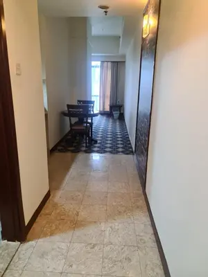 a hallway of a hotel with a table and chairs at Soho Service Apartment at Times Square KL in Kuala Lumpur