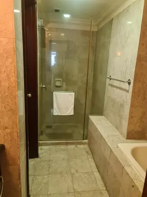 a bathroom with a shower with a sink and a toilet at Soho Service Apartment at Times Square KL in Kuala Lumpur