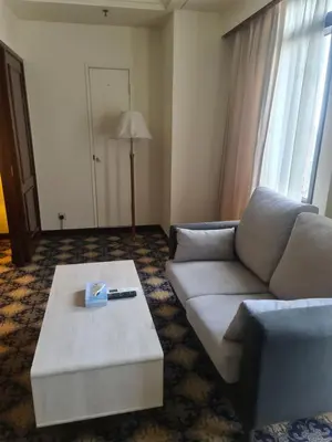 a living room with a couch and a coffee table at Soho Service Apartment at Times Square KL in Kuala Lumpur