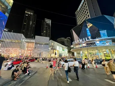 a crowd of people walking on a city street at night at Dorsett 2BR 6Pax Pavilion Bukit Bintang TRX KLCC in Kuala Lumpur