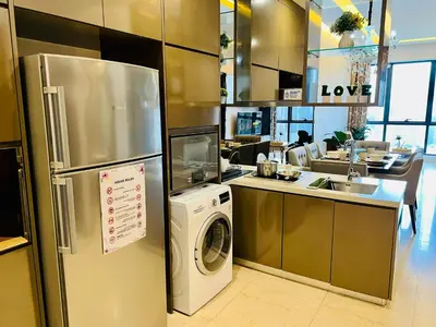 a kitchen with a refrigerator and a washing machine at Dorsett 2BR 6Pax Pavilion Bukit Bintang TRX KLCC in Kuala Lumpur