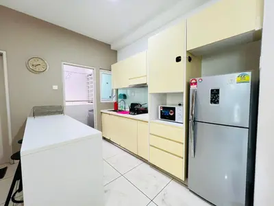 a kitchen with a white refrigerator and cabinets at Sunway Velocity V Residence by DeUrban in Kuala Lumpur