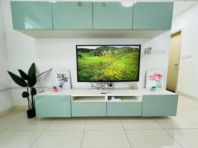 a living room with a television on a white cabinet at Sunway Velocity V Residence by DeUrban in Kuala Lumpur
