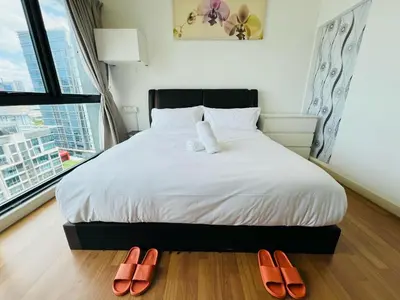 a bedroom with a bed with two slippers on the floor at Sunway Velocity V Residence by DeUrban in Kuala Lumpur