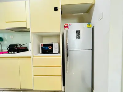 a white refrigerator in a kitchen with a microwave at Sunway Velocity V Residence by DeUrban in Kuala Lumpur