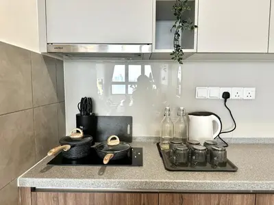 a kitchen with a counter top with a stove top at M Vertica, Sunway Velocity Kuala Lumpur by Rverse Suite in Kuala Lumpur